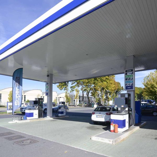 Aquila Energie stazione di rifornimento carburante con pompe e veicoli in attesa.